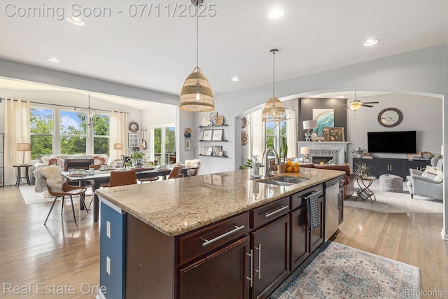 59141 Peters Barn Dr, South Lyon, MI 48178 - kitchen with open floor plan, arched walkways, a ceiling fan, light wood-style flooring, and recessed lighting