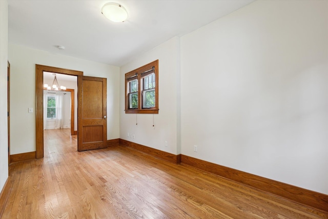 450 S 1st St, Ann Arbor, MI 48103 - empty room featuring a chandelier, light wood-style flooring, and a smoke detector
