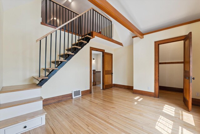 450 S 1st St, Ann Arbor, MI 48103 - unfurnished living room featuring hardwood / wood-style flooring, stairs, high vaulted ceiling, and beamed ceiling