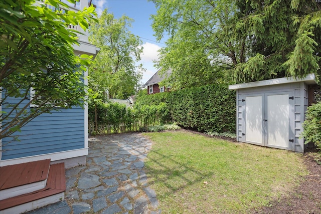450 S 1st St, Ann Arbor, MI 48103 - view of grassy yard featuring a storage shed and a patio area
