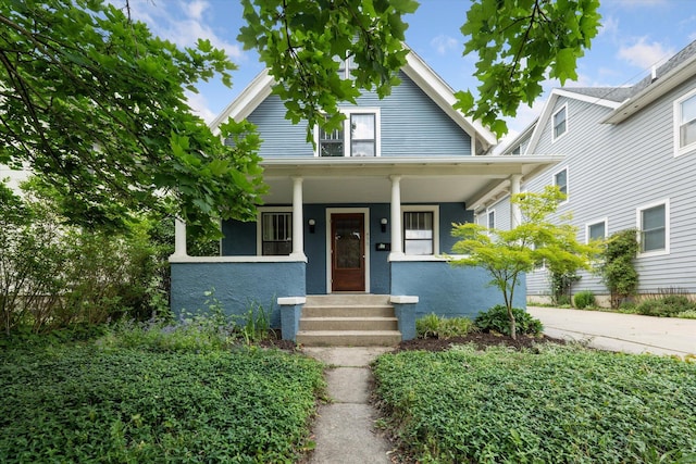 450 S 1st St, Ann Arbor, MI 48103 - bungalow-style home featuring a porch, driveway, and stucco siding