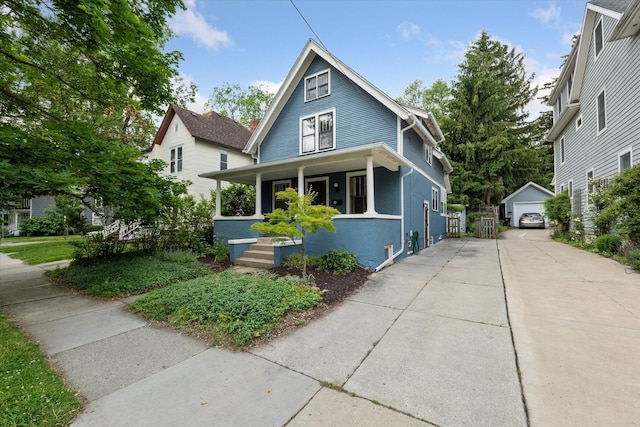 450 S 1st St, Ann Arbor, MI 48103 - view of front of home with covered porch, an outdoor structure, a garage, and driveway
