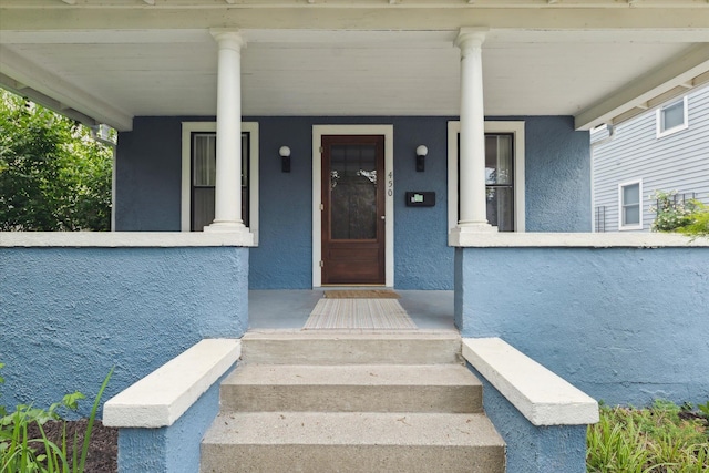 450 S 1st St, Ann Arbor, MI 48103 - doorway to property with stucco siding and covered porch