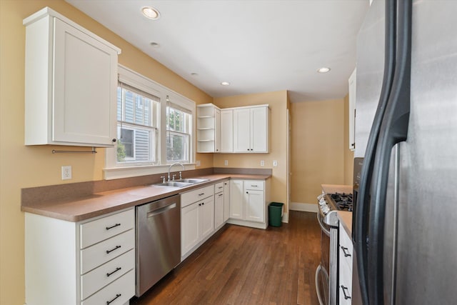 450 S 1st St, Ann Arbor, MI 48103 - kitchen featuring appliances with stainless steel finishes, dark wood finished floors, white cabinets, recessed lighting, and open shelves