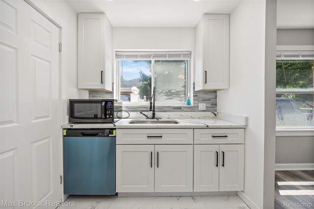 1122 Symes Ct, Royal Oak, MI 48067 - kitchen with dishwashing machine, stainless steel microwave, backsplash, and white cabinetry