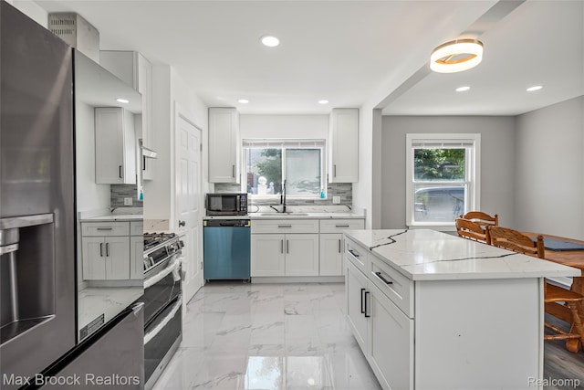 1122 Symes Ct, Royal Oak, MI 48067 - kitchen featuring appliances with stainless steel finishes, plenty of natural light, backsplash, recessed lighting, and light stone countertops