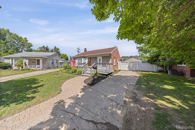 1122 Symes Ct, Royal Oak, MI 48067 - view of front of property with a porch, a gate, a chimney, brick siding, and driveway