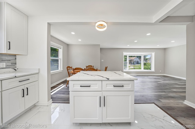 1122 Symes Ct, Royal Oak, MI 48067 - kitchen featuring healthy amount of natural light, recessed lighting, light marble finish flooring, and light stone countertops