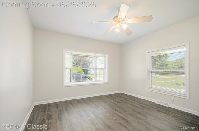 207 Washington St, Holly, MI 48442 - spare room featuring plenty of natural light, dark wood-type flooring, and ceiling fan