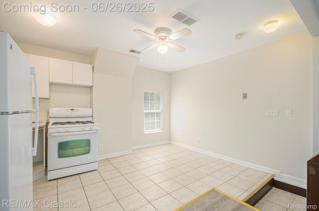 207 Washington St, Holly, MI 48442 - kitchen featuring white appliances, light tile patterned floors, a ceiling fan, and white cabinets