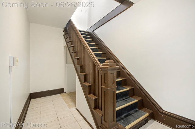 207 Washington St, Holly, MI 48442 - staircase with tile patterned floors and baseboards