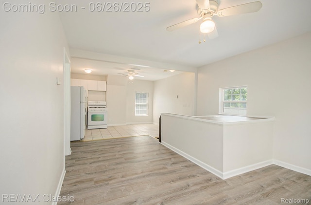 207 Washington St, Holly, MI 48442 - hallway featuring light wood-style flooring and baseboards