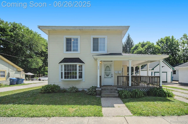 207 Washington St, Holly, MI 48442 - view of front of house with covered porch and a front yard