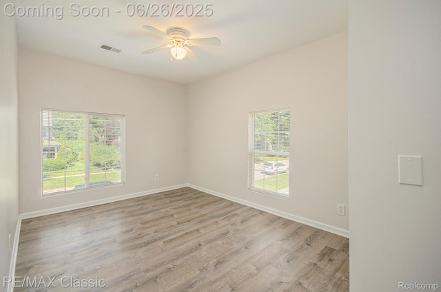 207 Washington St, Holly, MI 48442 - empty room with ceiling fan and wood finished floors