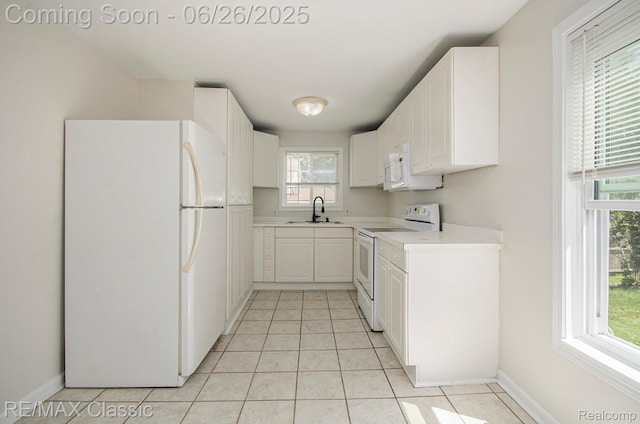 207 Washington St, Holly, MI 48442 - kitchen with white appliances, plenty of natural light, light countertops, and light tile patterned floors
