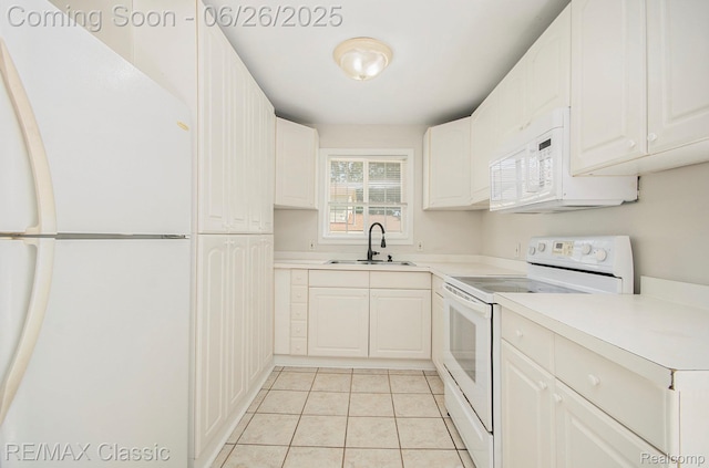 207 Washington St, Holly, MI 48442 - kitchen with white appliances, light tile patterned floors, light countertops, and white cabinets