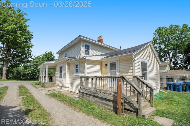 207 Washington St, Holly, MI 48442 - view of front of home featuring a chimney, a shingled roof, and dirt driveway