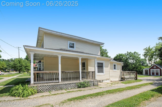 207 Washington St, Holly, MI 48442 - view of front of home with a porch and a storage shed