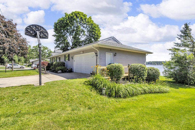 38 Evans Trl, Tipton, MI 49287 - view of front of home with concrete driveway, an attached garage, and a front lawn