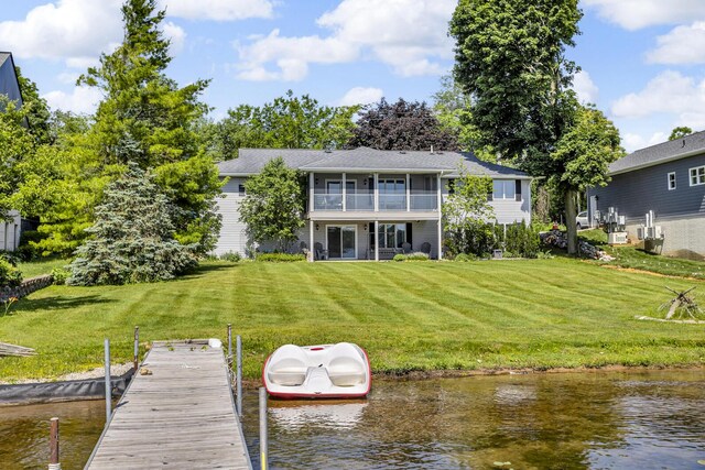 38 Evans Trl, Tipton, MI 49287 - back of house with a water view, a yard, and a balcony