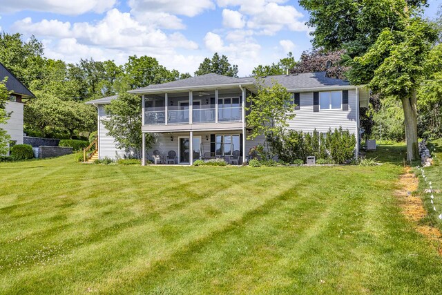 38 Evans Trl, Tipton, MI 49287 - rear view of property with a sunroom and a lawn