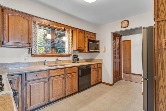38 Evans Trl, Tipton, MI 49287 - kitchen with dishwasher, built in microwave, freestanding refrigerator, range, and light flooring