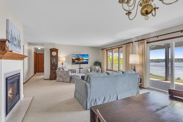 38 Evans Trl, Tipton, MI 49287 - living room with a fireplace with flush hearth, light colored carpet, and a chandelier