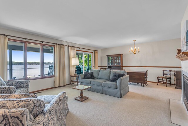 38 Evans Trl, Tipton, MI 49287 - living area with a chandelier, light colored carpet, a fireplace, and a water view