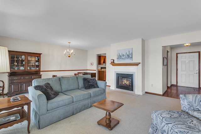 38 Evans Trl, Tipton, MI 49287 - living area with a chandelier, carpet flooring, and a glass covered fireplace