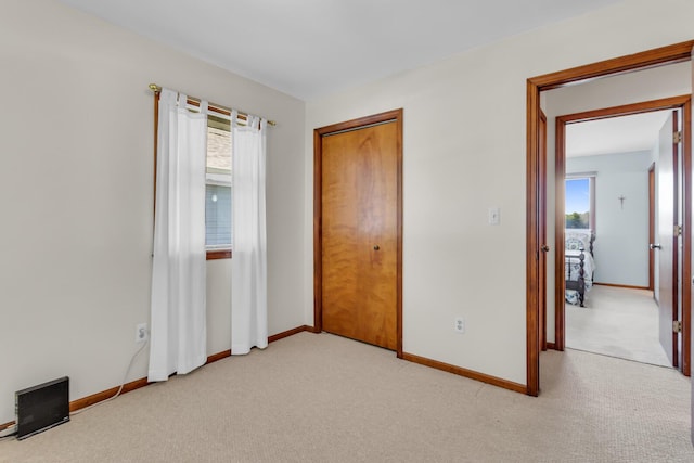 38 Evans Trl, Tipton, MI 49287 - unfurnished bedroom with light carpet and a closet