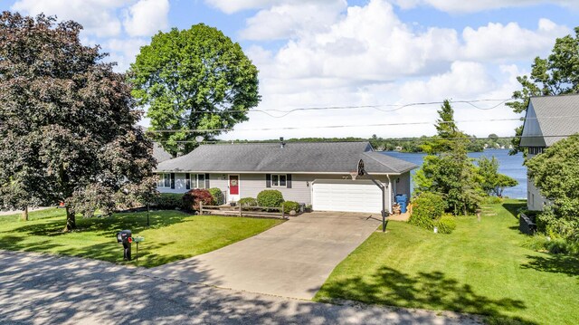38 Evans Trl, Tipton, MI 49287 - view of front of house featuring a garage, a front lawn, and driveway