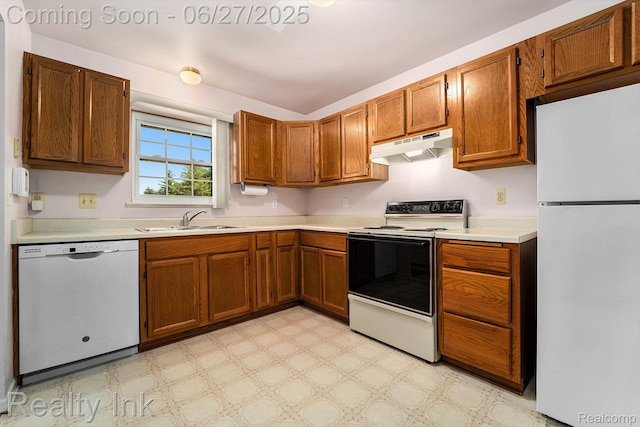 35898 Castlewood Ct, Westland, MI 48185 - kitchen with white appliances, under cabinet range hood, light countertops, and brown cabinetry