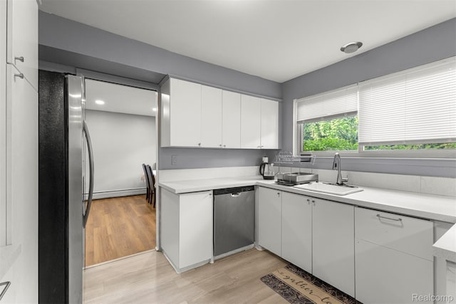 2738 Berry Dr, Bloomfield Hills, MI 48304 - kitchen with stainless steel appliances, white cabinetry, light wood-type flooring, and light countertops
