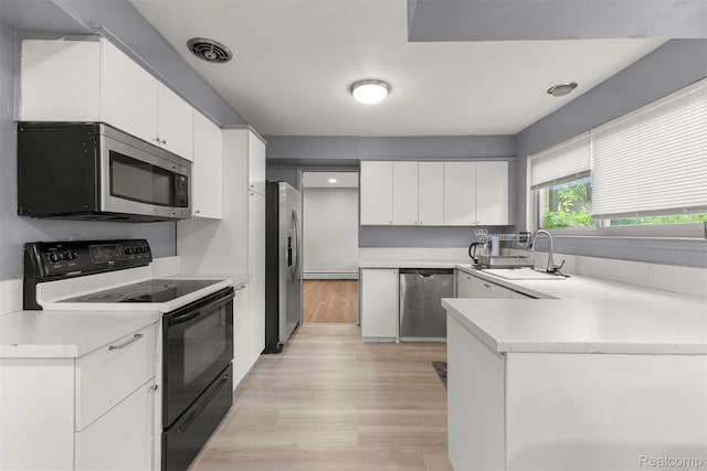2738 Berry Dr, Bloomfield Hills, MI 48304 - kitchen with stainless steel appliances, light wood-style floors, light countertops, white cabinetry, and a peninsula