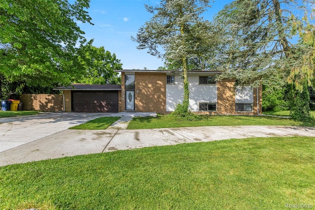 2738 Berry Dr, Bloomfield Hills, MI 48304 - view of front facade with driveway, a front lawn, brick siding, and an attached garage
