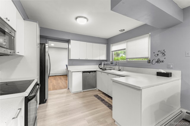 2738 Berry Dr, Bloomfield Hills, MI 48304 - kitchen featuring appliances with stainless steel finishes, light wood-style floors, white cabinets, light countertops, and a peninsula