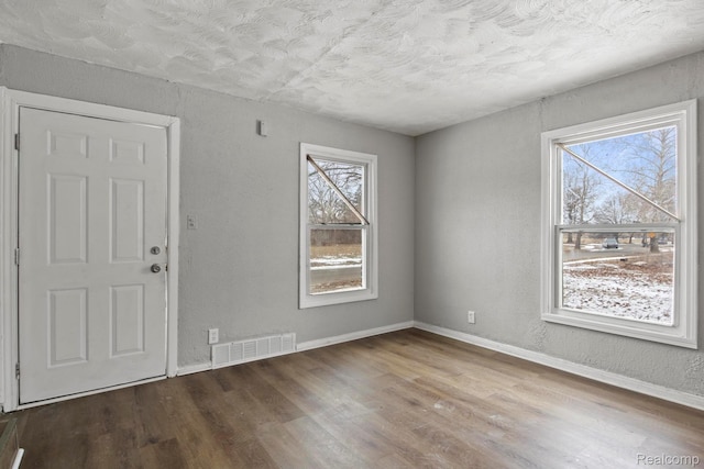 9110 Mansfield St, Detroit, MI 48228 - foyer featuring wood finished floors and a textured ceiling