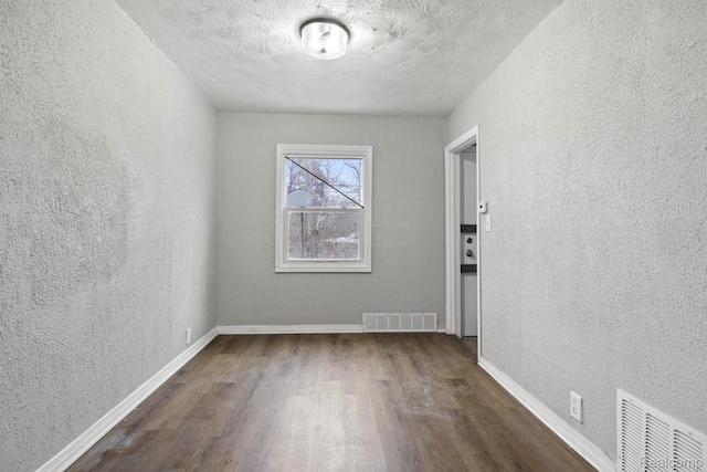9110 Mansfield St, Detroit, MI 48228 - unfurnished room featuring a textured wall and dark wood-style floors