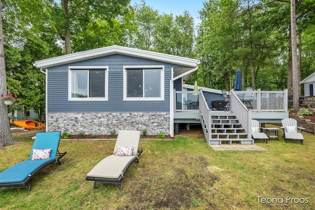 12865 S Englewright Dr, Sand Lake, MI 49343 - rear view of property with a wooden deck, a lawn, and stairs