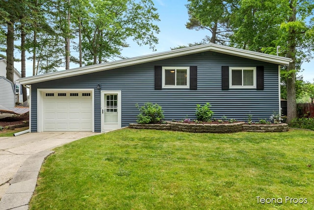 12865 S Englewright Dr, Sand Lake, MI 49343 - view of front of property featuring concrete driveway, a front yard, and an attached garage