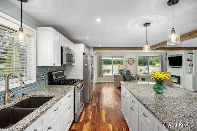 12865 S Englewright Dr, Sand Lake, MI 49343 - kitchen featuring appliances with stainless steel finishes, open floor plan, dark wood-style floors, white cabinets, and recessed lighting