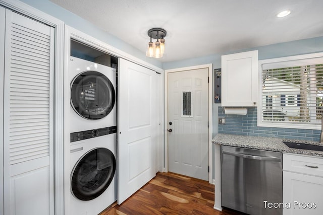 12865 S Englewright Dr, Sand Lake, MI 49343 - washroom with stacked washer / dryer, dark wood-style floors, and recessed lighting