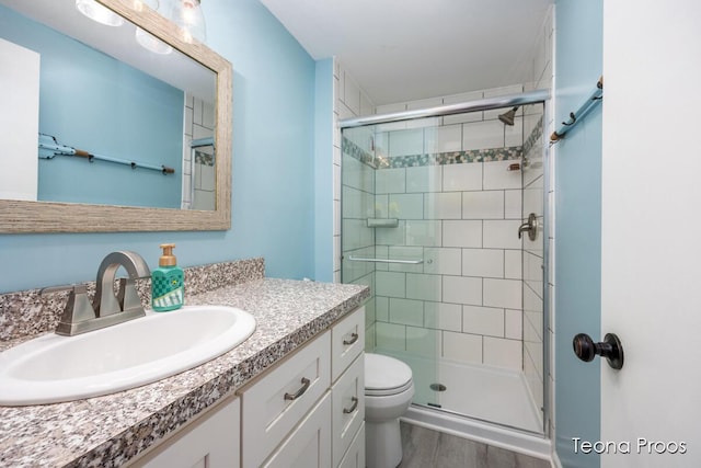12865 S Englewright Dr, Sand Lake, MI 49343 - bathroom featuring vanity, a shower stall, and wood finished floors