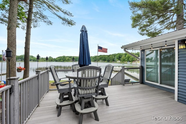 12865 S Englewright Dr, Sand Lake, MI 49343 - wooden terrace with a water view and outdoor dining area