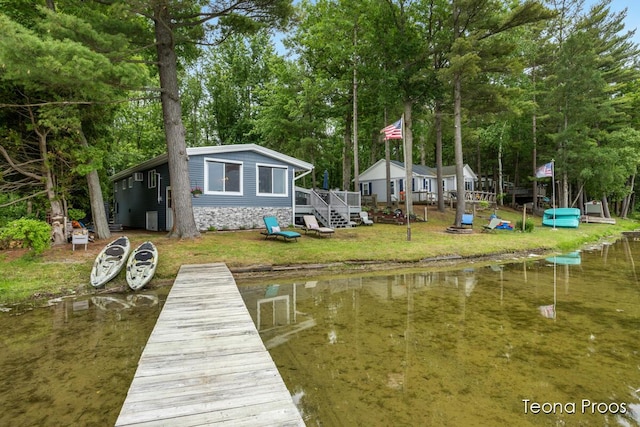 12865 S Englewright Dr, Sand Lake, MI 49343 - dock with view of scattered trees, a water view, and a yard