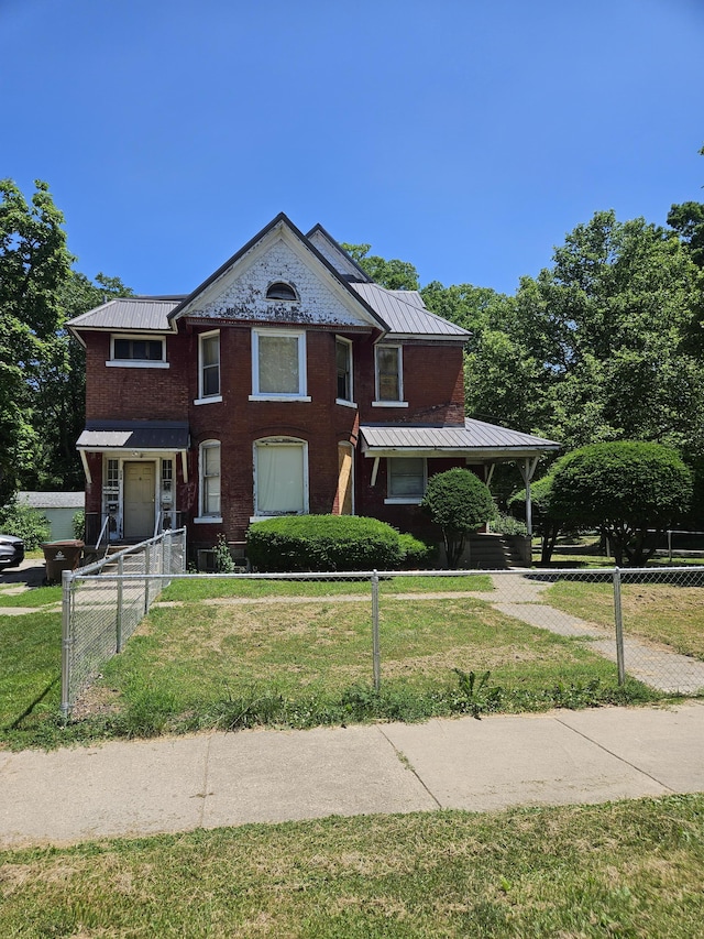 702 N Superior St, Albion, MI 49224 - view of front of home with a fenced front yard, a metal roof, and a standing seam roof