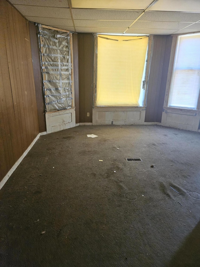 702 N Superior St, Albion, MI 49224 - carpeted spare room featuring a drop ceiling and wood walls