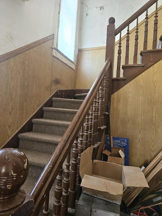702 N Superior St, Albion, MI 49224 - staircase with wood walls and wainscoting
