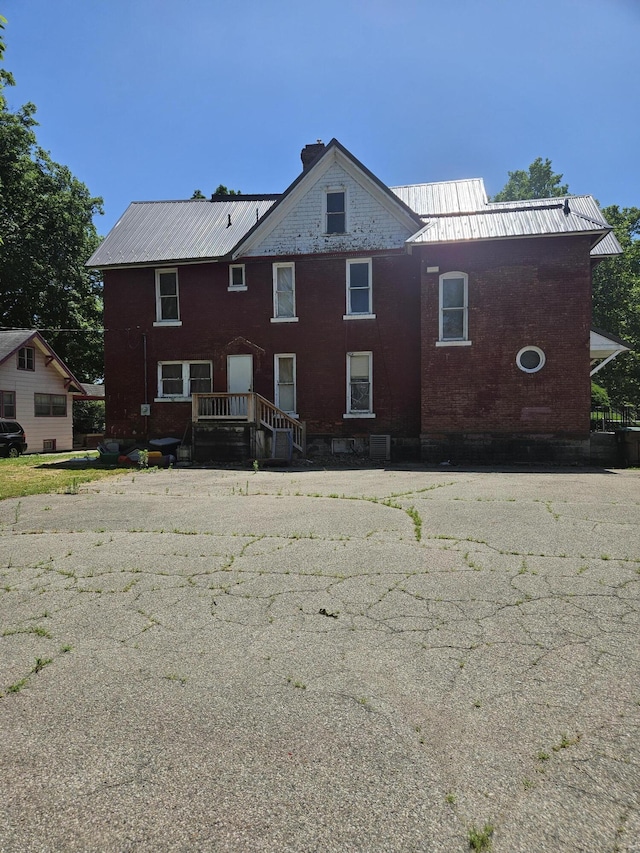 702 N Superior St, Albion, MI 49224 - rear view of house with brick siding and a metal roof