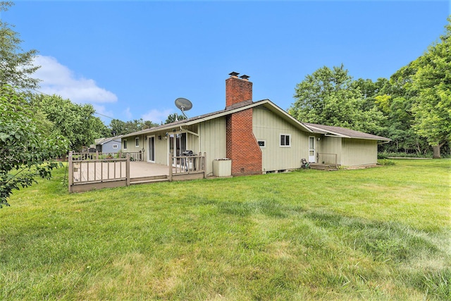 8025 Fosdick Rd, Saline, MI 48176 - rear view of house with a chimney, a lawn, and a wooden deck